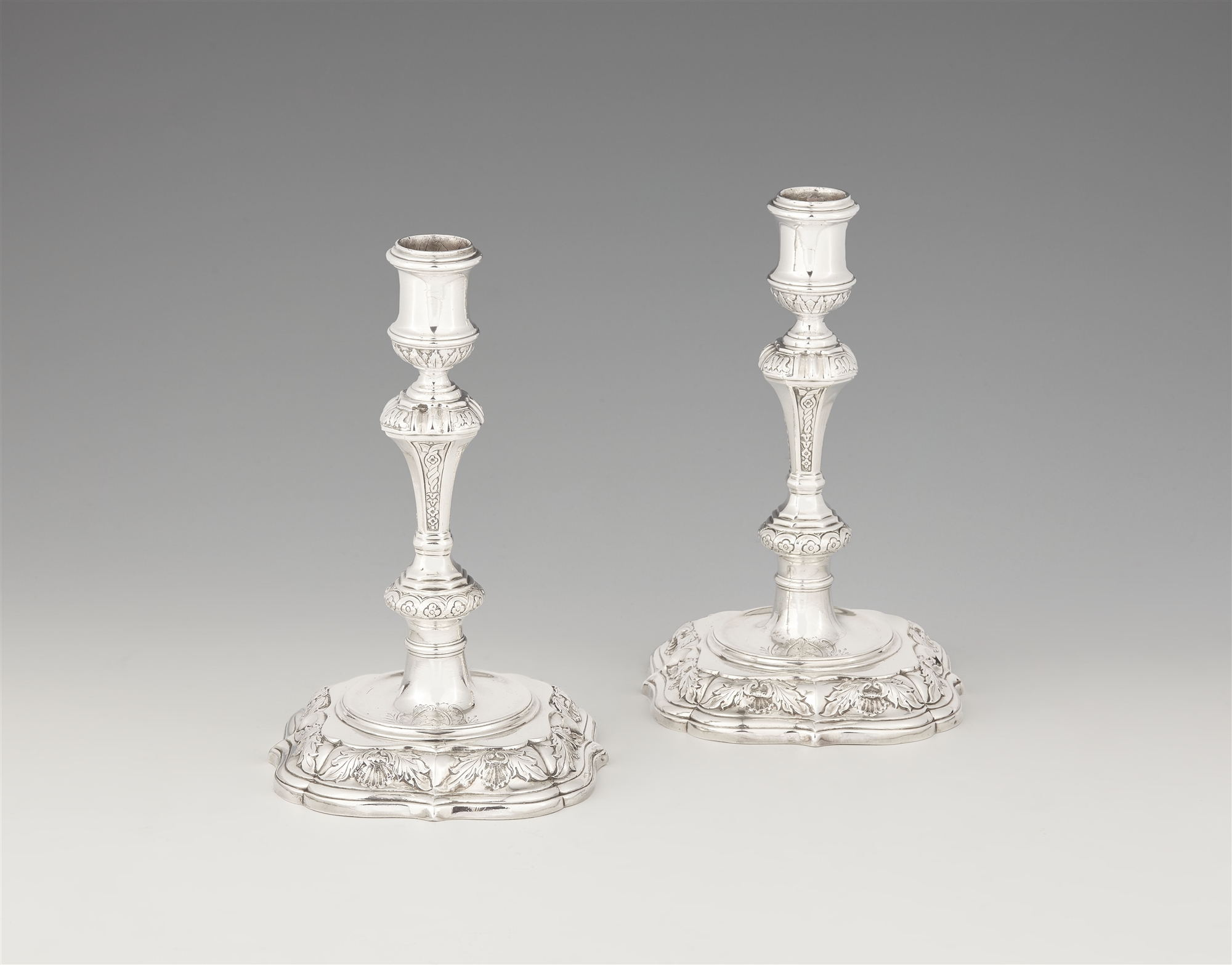 A pair of George I silver candlesticks
