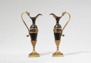 A pair of Empire style decorative pitchers
