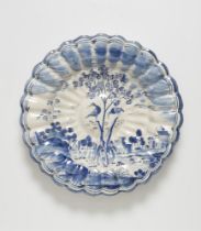 A Hanau faience fan platter with central tree motif