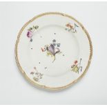 A Meissen porcelain plate from a dinner service with woodcut style flowers