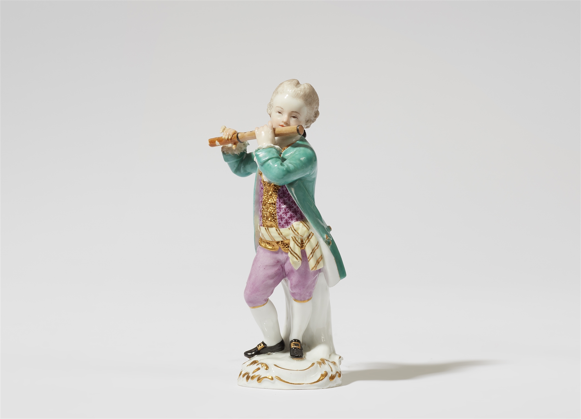 A Meissen porcelain figure of a boy with a flute