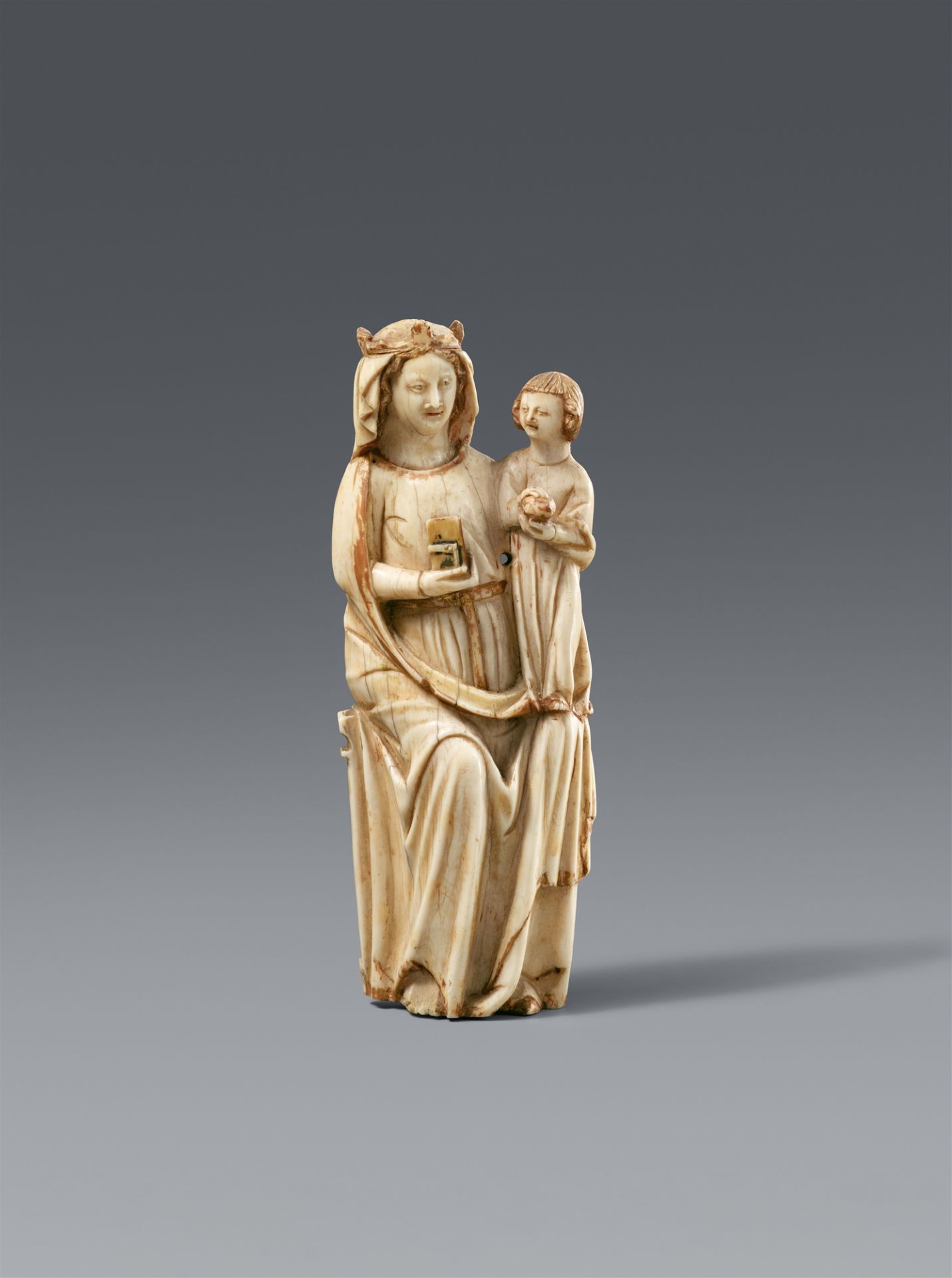 A French carved ivory figure of the Virgin enthroned, second half 14th century