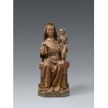 A carved wood figure of the Madonna enthroned, presumably Burgundy, late 14th century