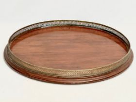 A large late Victorian mahogany tray with pierced brass gallery. 56x6cm
