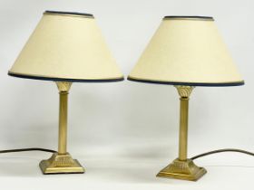 A pair of Christopher Wray brass table lamps. Bases measure 26.5cm
