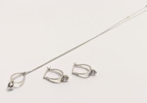 A silver necklace and pendant with a pair of silver earrings.