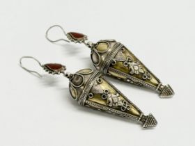 A pair of large unmarked silver earrings. 8cm.