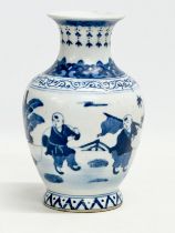 A Chinese Qing Dynasty, Kangxi mark blue and white vase. Late 19th/early 20th century