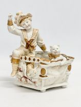 A late 19th century porcelain boy sitting with cat. Makers stamp underneath. 16x12x18cm