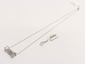 A silver necklace and pendant with other silver pendant.