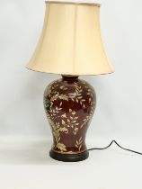 A large enamelled flower design table lamp. 70cm