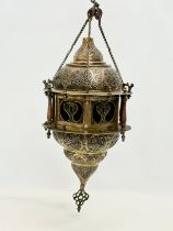 A large early 20th century Moroccan brass ceiling lantern with stained glass panels. 80cm hanging.