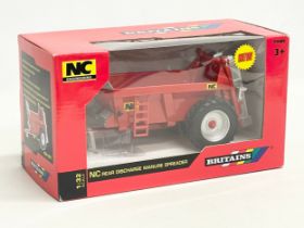 An unused Britains NC Engineering NC Discharge Manure Spreader in box. 1:32 scale. 25x12x14cm