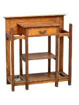 An early 20th century late Victorian/Edwardian oak stickstand with drawer and trays. Circa 1900.