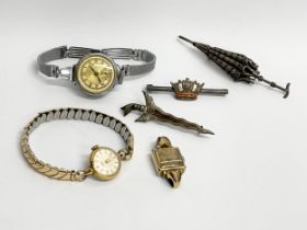 A collection of vintage watches and brooches.