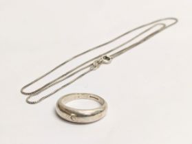 A silver necklace with a silver ring. Chain measures 22cm clasped
