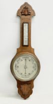 An Edwardian oak barometer. 81cm