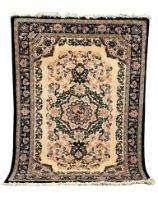 A large Middle Eastern style wool rug. 169x249xm