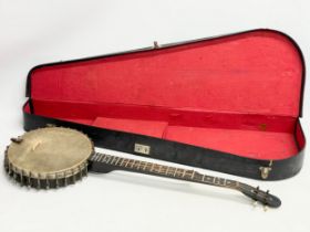 A vintage banjo with case. Banjo measures 89cm