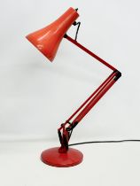 A red model 90 anglepoise lamp.