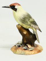 A Royal Crown Derby “Green Woodpecker” figurine. 15cm