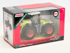 An unused Britains Claas Xerion 5000 Tractor in box. Die-Cast Model and Plastic Parts. 29x15x17cm