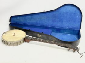 A Fred Langham banjo with case. Banjo measures 90cm.