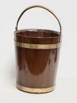 A George III mahogany brass bound peat bucket with brass handle. Circa 1790. 38x37x46cm not