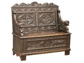 A Victorian carved oak hall bench with lift up storage. Circa 1870-1880. 107x43.5x100cm