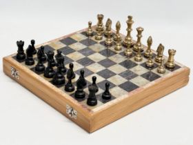 An onyx and brass chess set. 30.5x30cm