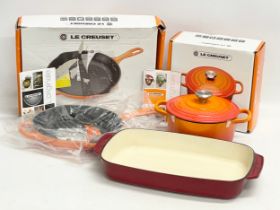 Le Creuset pots and pans with 2 boxes.