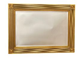 An ornate gilt framed bevelled mirror. 94x69cm