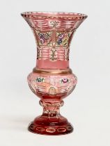 A Bohemian Cranberry Glass Moser style vase with embossed painted flower and gilt decoration. 1950’