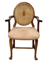 A vintage armchair with bergere back.