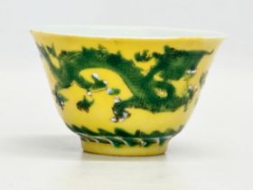 A 19th century Chinese emperor Tongzhi (1856-1875) yellow ground porcelain rice bowl with green