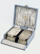 A pair of silver vanity brushes with case by McDowell’s of Dublin. Birmingham.