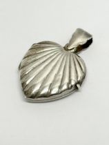 A 925 silver heart locket pendant. 4.64 grams.