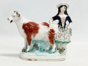 A mid 19th century Staffordshire Cow Creamer. 21x18.5cm