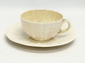 A late 19th century first period Belleek pottery ‘Tridacna’ cup and saucer. Circa 1863-1891.