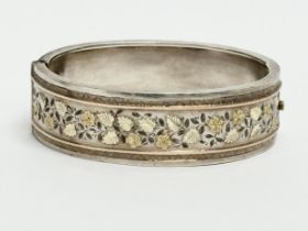A late 19th century ornate silver bangle. 28.68 grams. 6.5x5cm