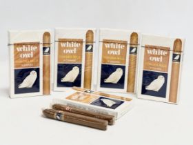 A collection of White Owl Corona Mild cigars. 4 packets unopened. 1 open.