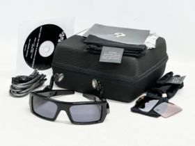 An Oakley Thump 512MB earphone sunglasses with case and accessories.