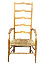 A vintage ladder back armchair with rush seat.
