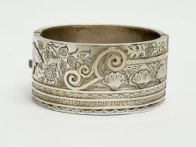 A late 19th century ornate silver bangle. By Sydenham Brothers. Birmingham. 38.39 grams. 6x5.5cm