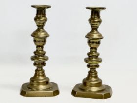 A pair of Victorian brass candlesticks. 26cm