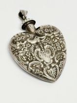 A silver perfume bottle pendant. Stamped MG. London. 18.47 grams. 4x6cm