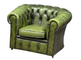 A deep button leather wingback armchair.