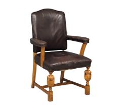 A 1930s oak and leather armchair in the Jacobean style.