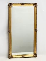A good quality vintage ornate gilt framed mirror. 46x86cm