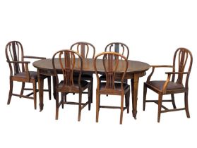 A large early 20th century inlaid mahogany extendable dining table and 6 chairs made for Headline
